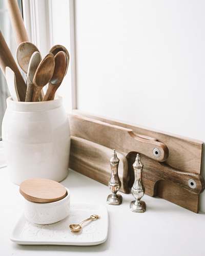 spoon brown wooden spoons on ceramic canister on white top surface cutlery